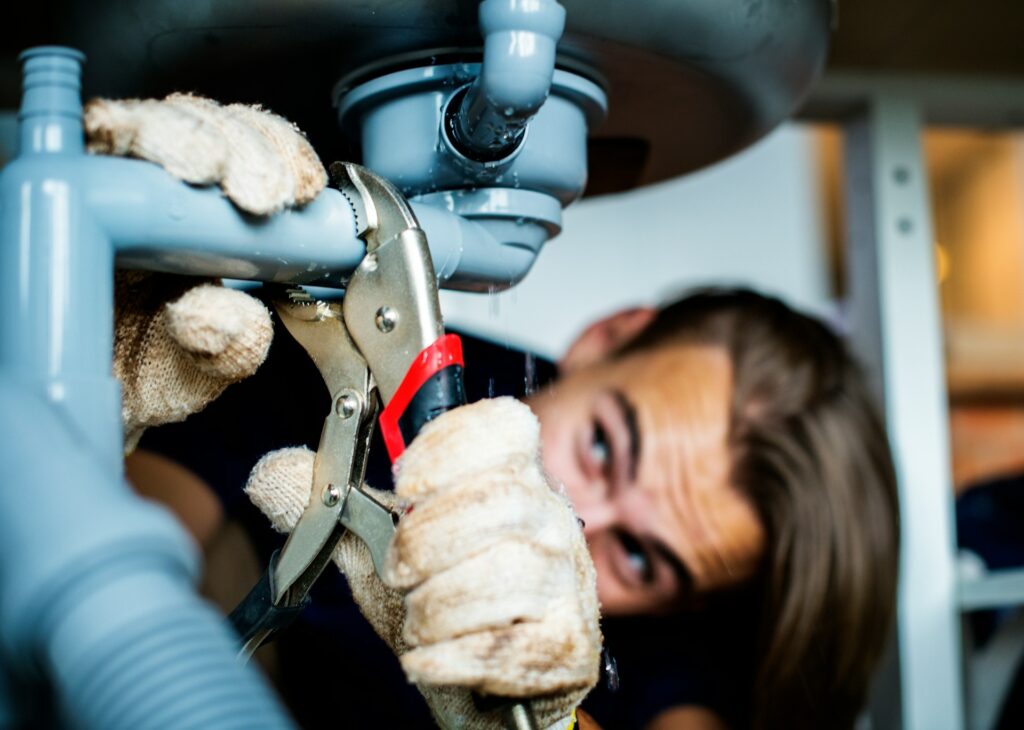 plumber fixing drain pipe